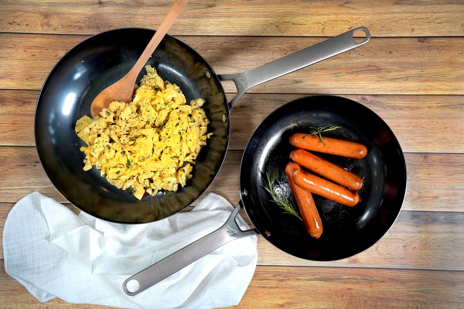 Carbon steel frying pans on a light background