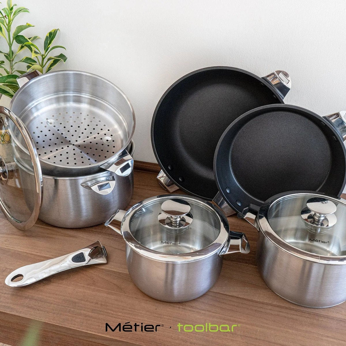 Metier removable-handle cookware and lids arranged on a kitchen worktop
